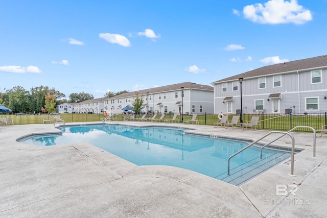 view of swimming pool with a patio area and a lawn