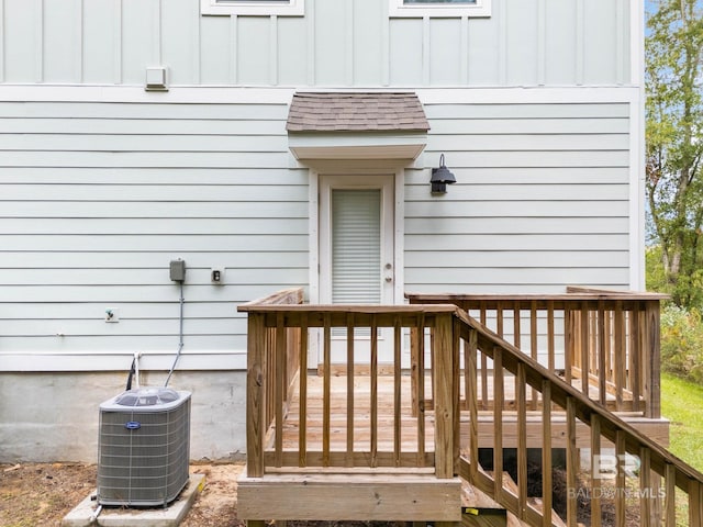 entrance to property featuring cooling unit and a wooden deck