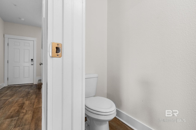 bathroom featuring wood-type flooring and toilet