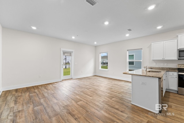 kitchen with white cabinetry, sink, dark stone countertops, and appliances with stainless steel finishes