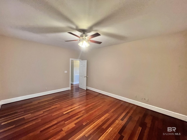 151 Mockingbird Ln, Atmore, AL 36502 - unfurnished room featuring ceiling fan, dark wood finished floors, and baseboards