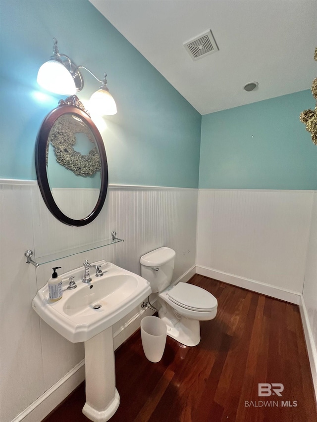 151 Mockingbird Ln, Atmore, AL 36502 - half bath with a wainscoted wall, wood finished floors, and toilet