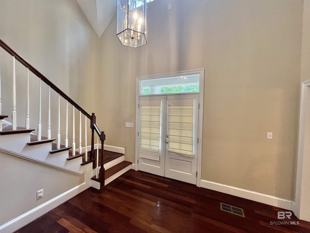 151 Mockingbird Ln, Atmore, AL 36502 - foyer featuring dark wood-style floors, stairs, baseboards, a chandelier, and high vaulted ceiling
