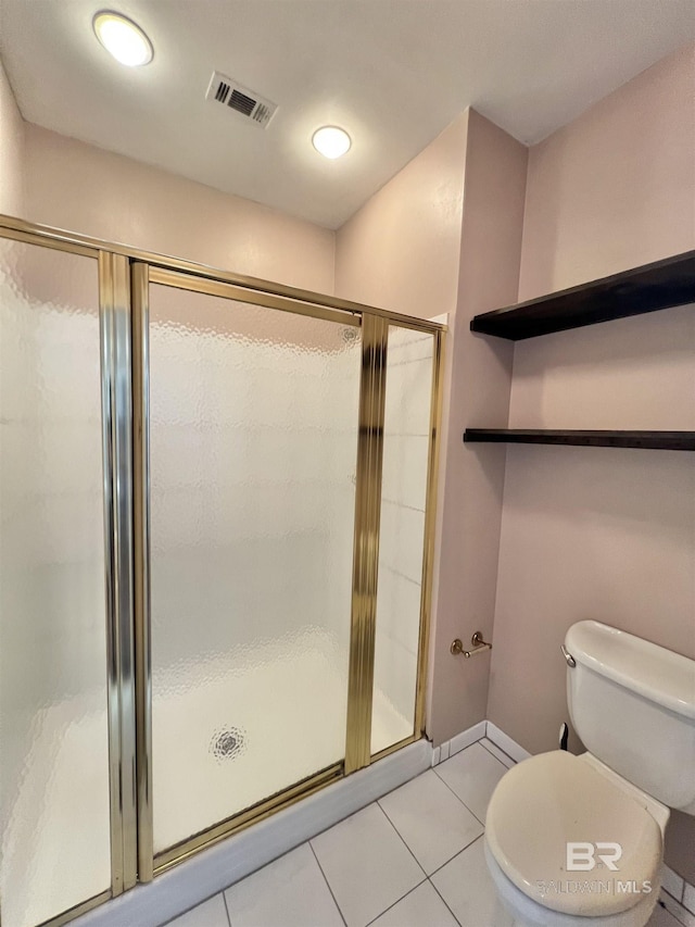 151 Mockingbird Ln, Atmore, AL 36502 - bathroom featuring tile patterned floors, toilet, a shower stall, and baseboards
