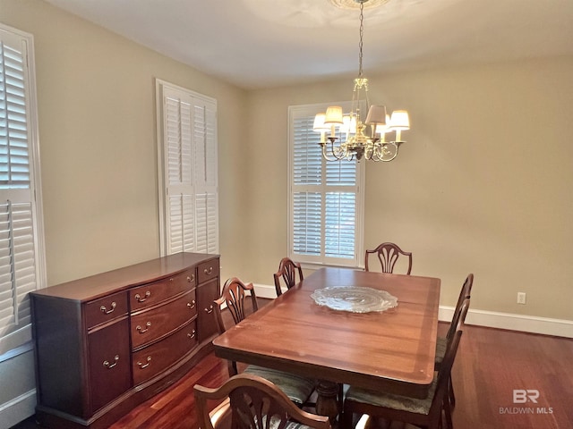 151 Mockingbird Ln, Atmore, AL 36502 - dining space featuring a chandelier, dark wood-style floors, and baseboards