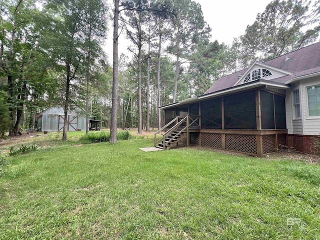 151 Mockingbird Ln, Atmore, AL 36502 - view of green lawn with a sunroom, an outdoor structure, and stairway
