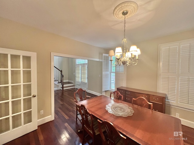 151 Mockingbird Ln, Atmore, AL 36502 - dining room with a chandelier, dark wood-style floors, baseboards, and stairs