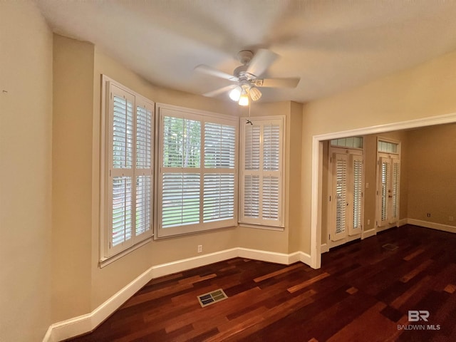 151 Mockingbird Ln, Atmore, AL 36502 - unfurnished room featuring a ceiling fan, dark wood-style flooring, and baseboards