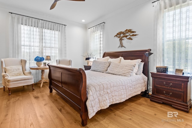 bedroom with ceiling fan and light hardwood / wood-style flooring