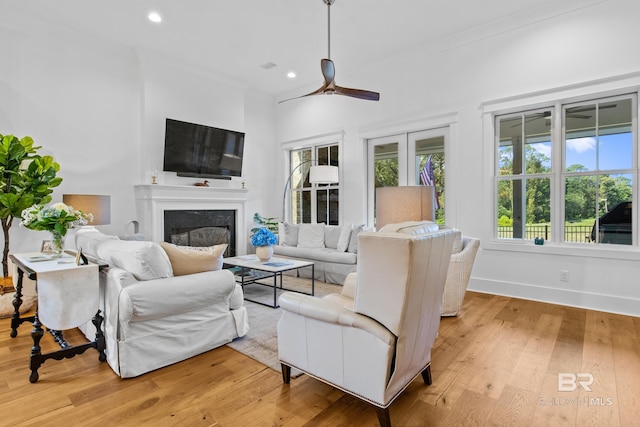 living room featuring light hardwood / wood-style flooring and ceiling fan