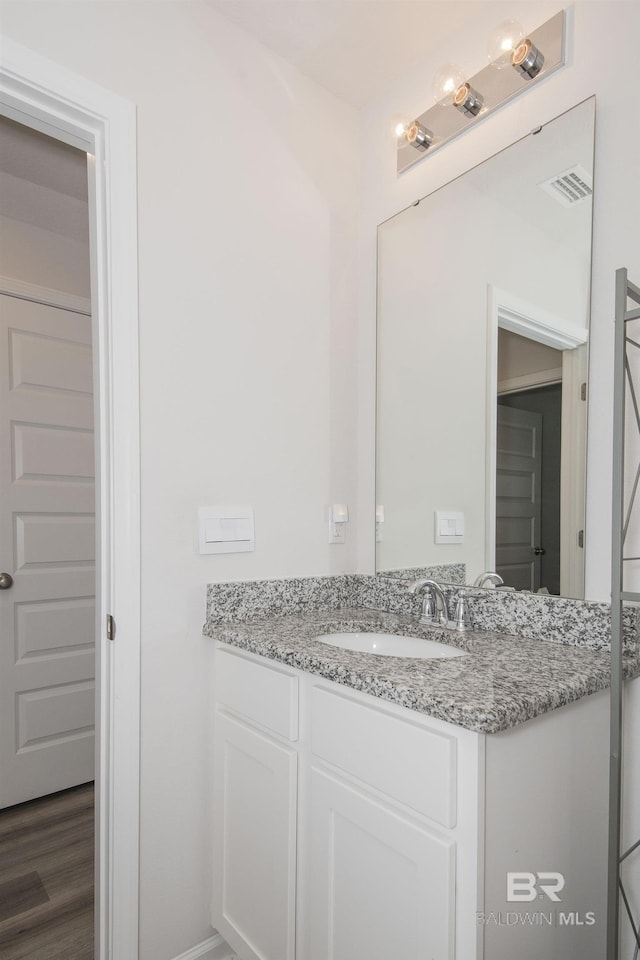 10909 Blacktail Loop, Pensacola, FL 32526 - bathroom featuring vanity and wood finished floors