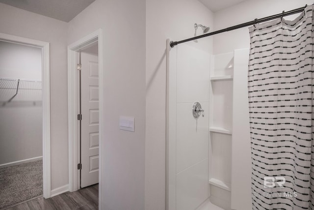 10909 Blacktail Loop, Pensacola, FL 32526 - bathroom featuring a shower stall, wood finished floors, and a spacious closet