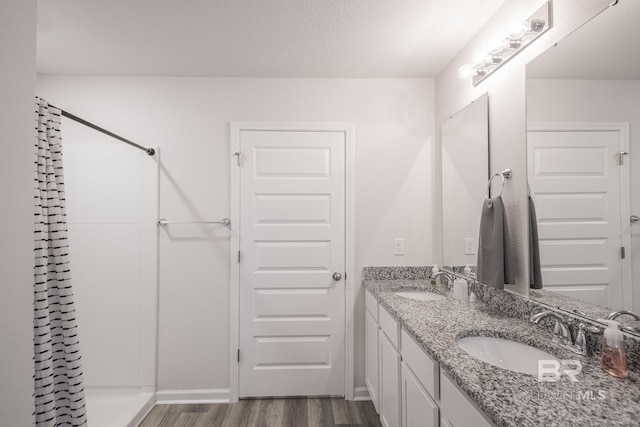 10909 Blacktail Loop, Pensacola, FL 32526 - bathroom with double vanity, wood finished floors, and a shower