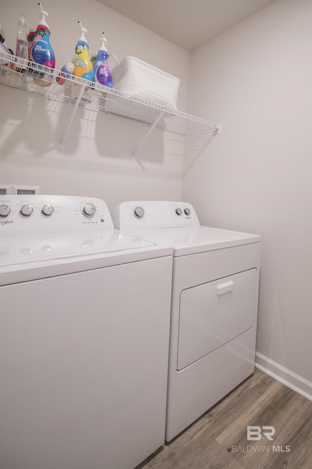10909 Blacktail Loop, Pensacola, FL 32526 - washroom with washing machine and clothes dryer and light wood finished floors