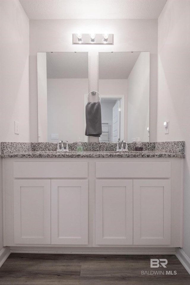 10909 Blacktail Loop, Pensacola, FL 32526 - full bathroom with double vanity and wood finished floors