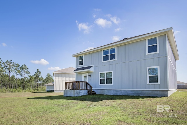 10909 Blacktail Loop, Pensacola, FL 32526 - rear view of house featuring board and batten siding and a yard