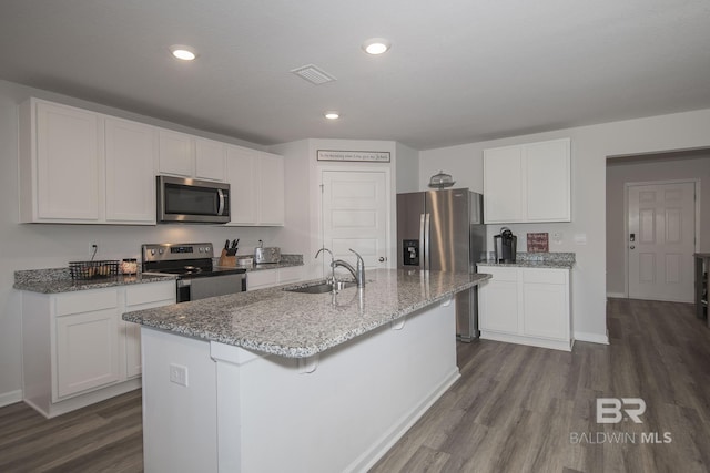 10909 Blacktail Loop, Pensacola, FL 32526 - kitchen featuring appliances with stainless steel finishes, dark wood-style flooring, light stone countertops, white cabinetry, and recessed lighting