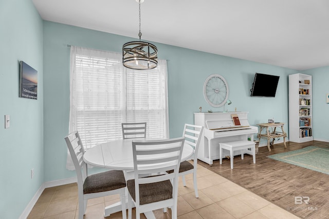 dining space with a chandelier, a healthy amount of sunlight, and tile patterned flooring