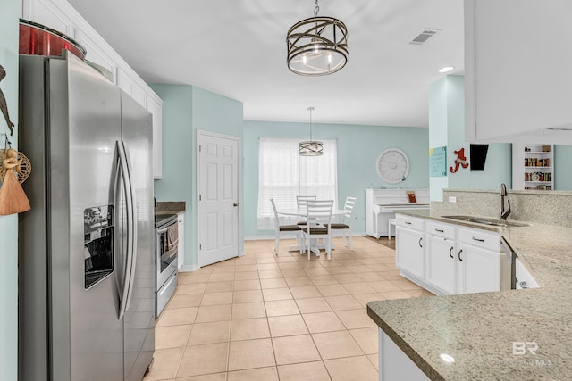 kitchen featuring a sink, stainless steel appliances, visible vents, white cabinetry, and light tile patterned floors