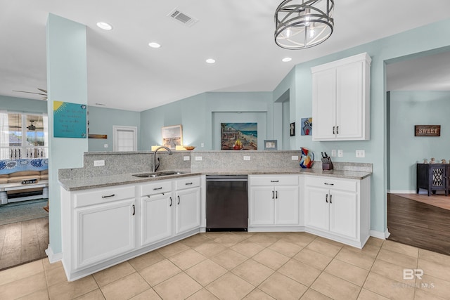 kitchen featuring a sink, light stone counters, visible vents, dishwasher, and white cabinets