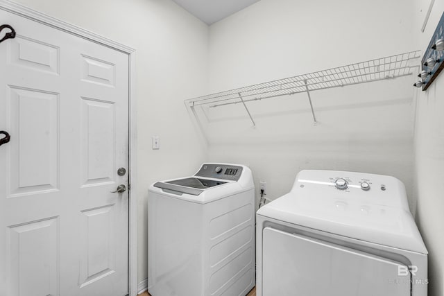 laundry area featuring washing machine and clothes dryer and laundry area