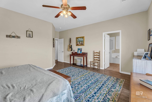 bedroom with ensuite bath, a ceiling fan, wood finished floors, and baseboards