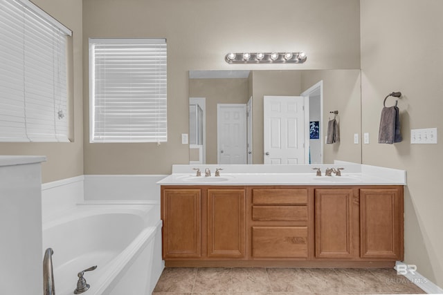 full bathroom with a sink, double vanity, and a garden tub