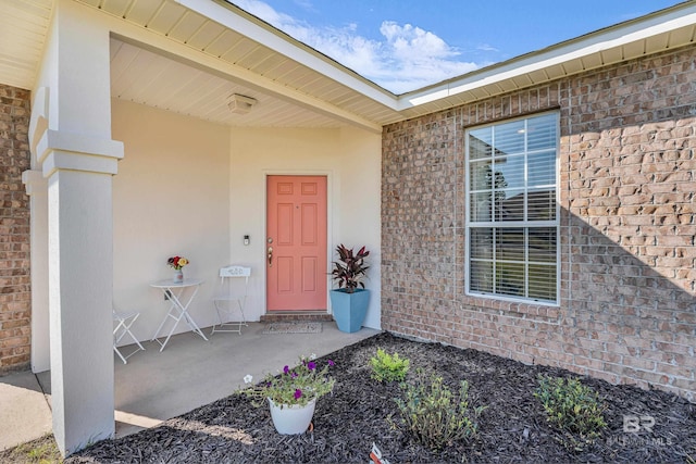 property entrance featuring brick siding