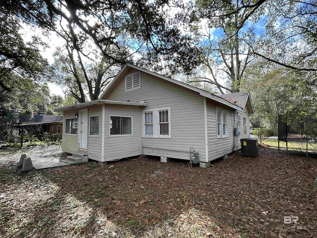 back of house featuring cooling unit