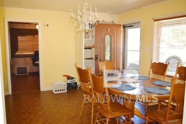 dining area with an inviting chandelier