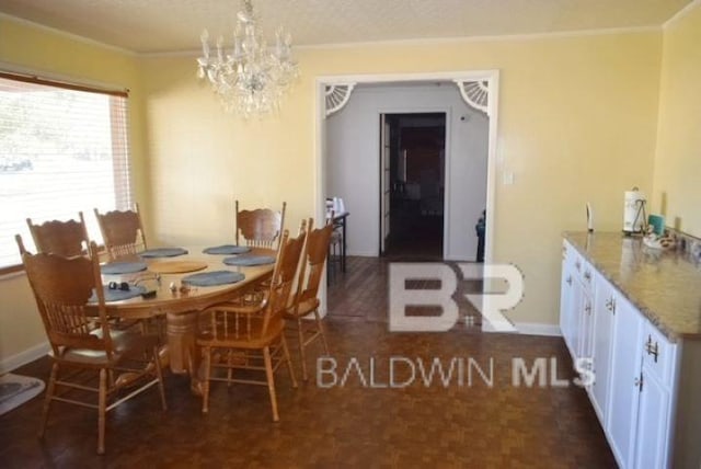 dining area featuring crown molding and a notable chandelier