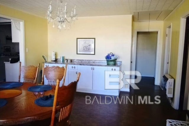 dining space with a chandelier and dark hardwood / wood-style floors