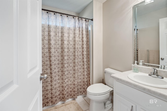 bathroom with tile patterned floors, vanity, and toilet