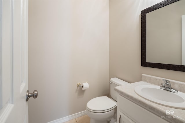 bathroom featuring tile patterned flooring, vanity, and toilet