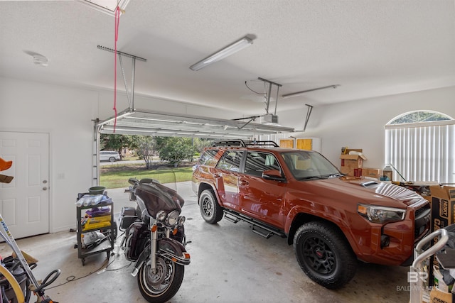 garage with a carport and a garage door opener