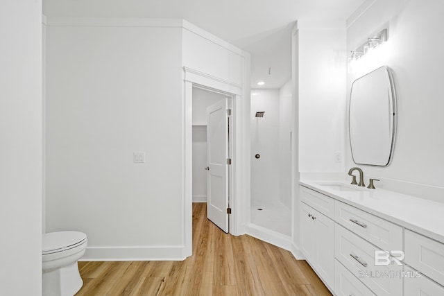 bathroom featuring wood-type flooring, toilet, and vanity