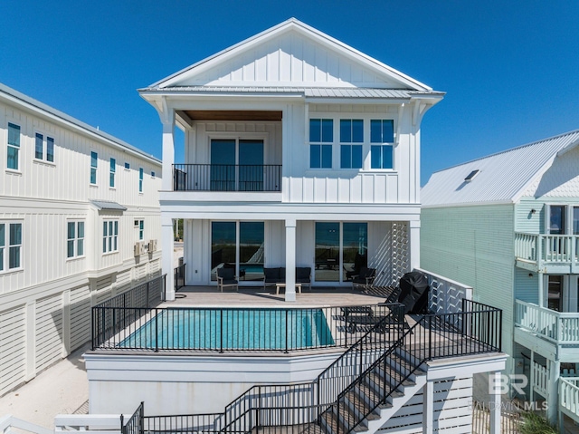 rear view of property with a balcony and a patio area