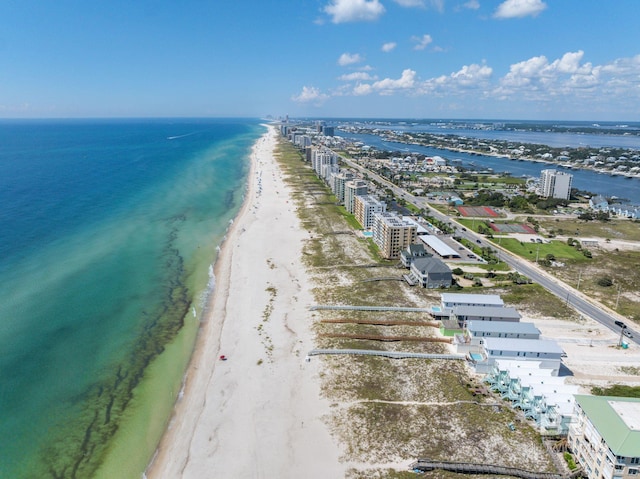 birds eye view of property featuring a beach view and a water view