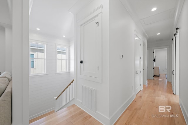 16761 Perdido Key Dr, Pensacola, FL 32507 - hall featuring a barn door, crown molding, and light hardwood / wood-style flooring