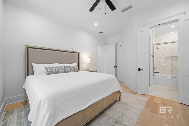 16761 Perdido Key Dr, Pensacola, FL 32507 - bedroom featuring ornamental molding, light wood-type flooring, ensuite bath, and ceiling fan