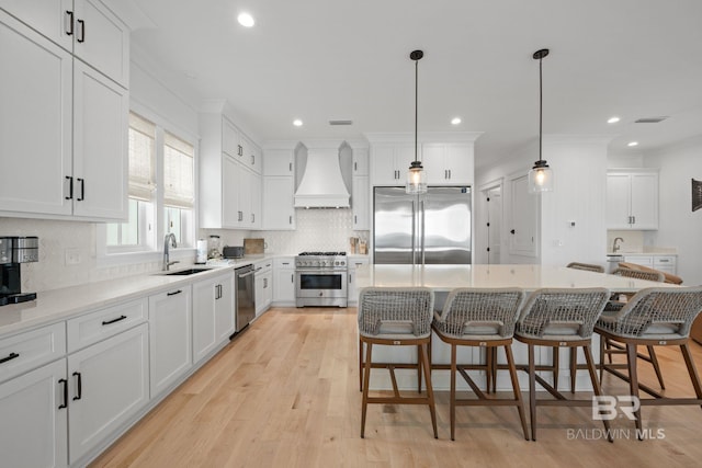 16761 Perdido Key Dr, Pensacola, FL 32507 - kitchen featuring a center island, premium appliances, custom exhaust hood, and decorative light fixtures