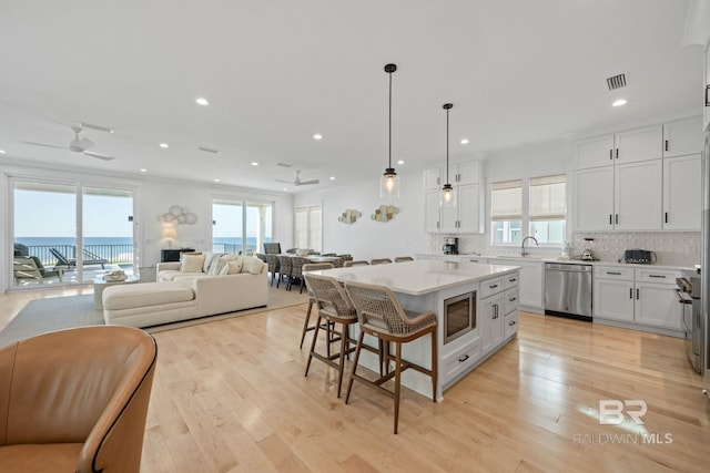 16761 Perdido Key Dr, Pensacola, FL 32507 - kitchen featuring appliances with stainless steel finishes, a healthy amount of sunlight, a center island, and ceiling fan