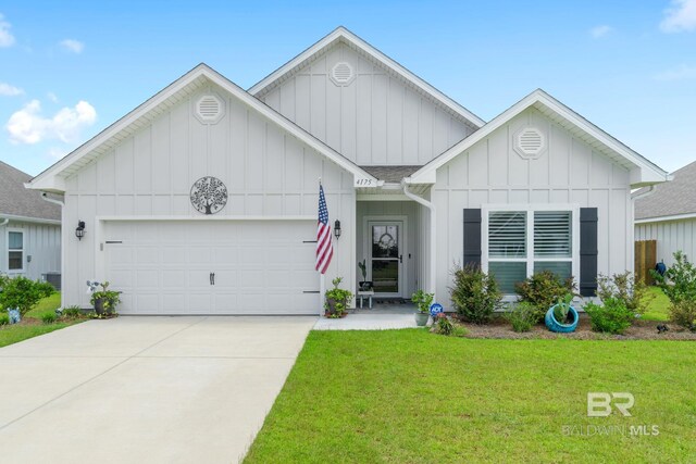 4175 Montague Dr, Gulf Shores, AL 36542 - view of front of house featuring board and batten siding, an attached garage, a front lawn, concrete driveway, and roof with shingles