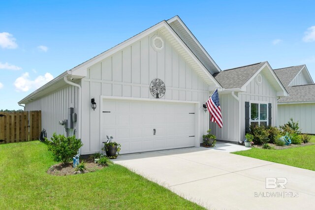 4175 Montague Dr, Gulf Shores, AL 36542 - view of front of home featuring board and batten siding, a shingled roof, an attached garage, and concrete driveway