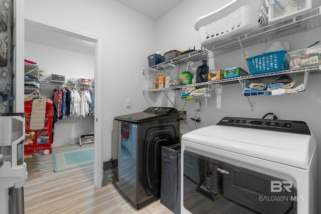 4175 Montague Dr, Gulf Shores, AL 36542 - laundry room featuring washer and dryer and light wood-type flooring