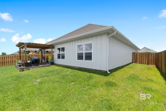 4175 Montague Dr, Gulf Shores, AL 36542 - rear view of property featuring a pergola, a fenced backyard, board and batten siding, a shingled roof, and a patio area
