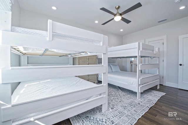 bedroom with dark hardwood / wood-style flooring and ceiling fan