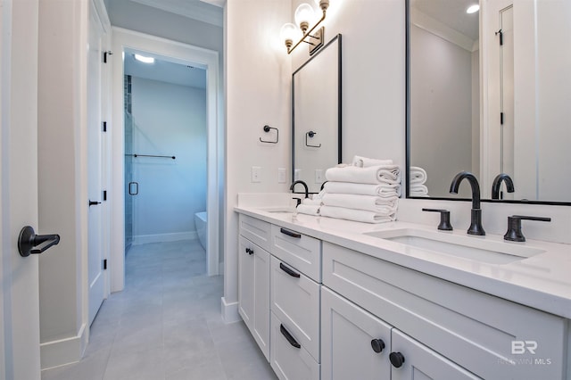 bathroom with tile patterned flooring, ornamental molding, vanity, an enclosed shower, and toilet