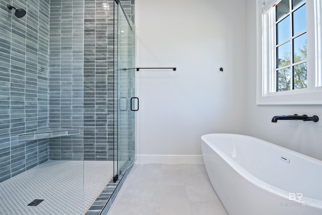 bathroom featuring tile patterned floors and shower with separate bathtub