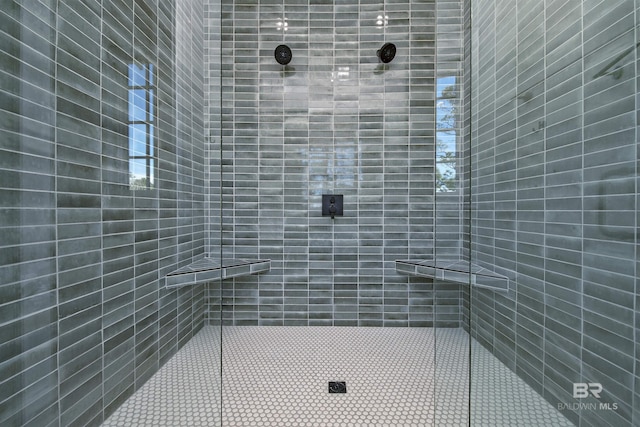 bathroom with tiled shower